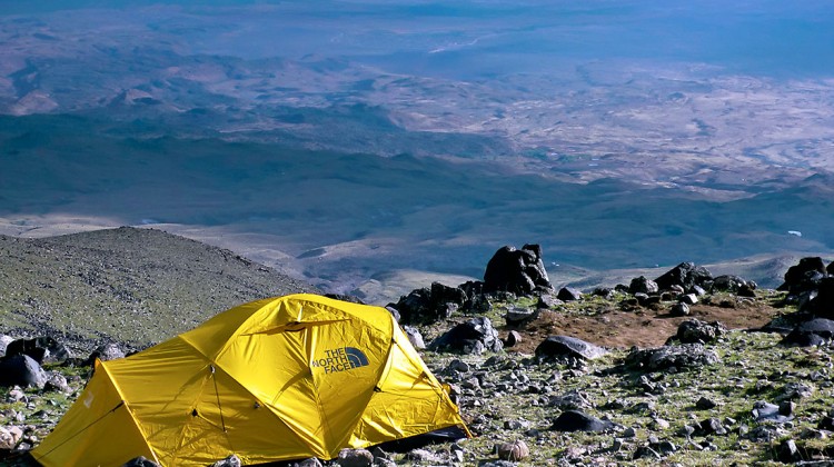 Tenda amarela da North Face instalada numa encosta do monte Ararat com vista para o vale.